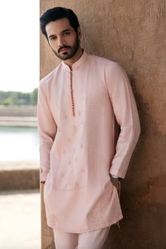 Introducing our light pink colored men's kurta, a majestic and exceptionally designed ensemble that is sure to turn heads. This kurta features stunning details of dori embroidered panel and motifs for daman, adding a touch of traditional charm to the overall look. The light pink color gives a sense of freshness and is perfect for summer occasions. The kurta is paired with a plain trouser, making it an ideal choice for any summer event. With its impeccable craftsmanship and attention to detail, this kurta is a must-have for any fashion-forward man looking to add a touch of sophistication to his wardrobe. Invest in this stunning light pink colored men's kurta and make a statement at any occasion. Tradition Outfits For Men, Pastel Pink Kurta For Men, Kurta For Wedding For Men, Man Pink Outfit, Light Pink Kurta For Men, Diwali Kurta For Men, Mens Traditional Wear Indian Kurta, Kurta For Men Traditional, Men In Kurta