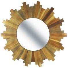 a wooden sunburst shaped mirror hanging on the wall in front of a white background