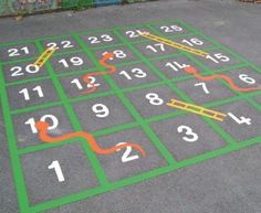 a parking lot with numbers and arrows painted on the ground in green, orange and white