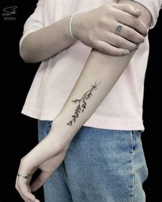 a woman with a small tattoo on her arm