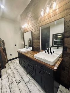 a large bathroom with two sinks and mirrors