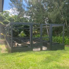 an outdoor garden area with raised planters in the middle and grass on the other side