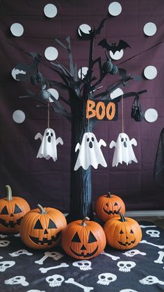 halloween decorations are displayed in front of a purple backdrop with black and white polka dots