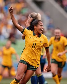 a female soccer player is celebrating her team's victory over the other team in a game