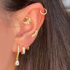 a woman's ear with three different types of piercings