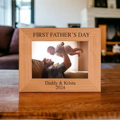 the first father's day frame is shown on a table with a baby in it