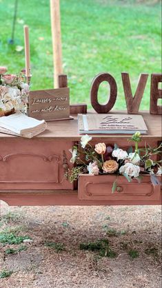 a wooden table topped with lots of flowers