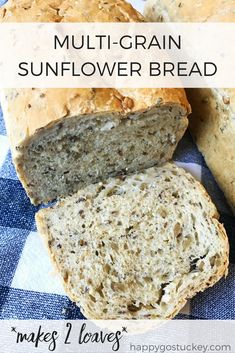 two loaves of multi grain sunflower bread on a blue and white checkered cloth