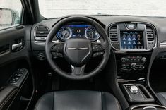 the interior of a car with black leather seats and gauges, steering wheel and dash board