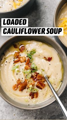 two bowls filled with loaded cauliflower soup on top of a gray countertop