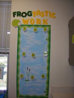 a classroom door decorated with frog plastic work