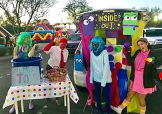 some people are dressed up in costumes and posing for a photo with an ice cream truck