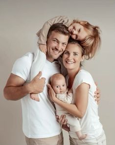 a man and woman are holding a baby