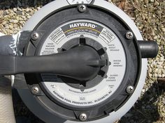 a close up view of a black and white fire hydrant with the lid open