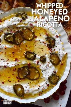 whipped honeyed jalapeno and ricotta dip in a white bowl on a plate