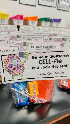 a sign that says be your awesome cell - fie and rock this test on it