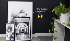 there is a black and white photo on the wall next to a potted plant