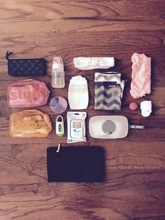 an assortment of personal items laid out on a wooden floor, including toiletries and baby products