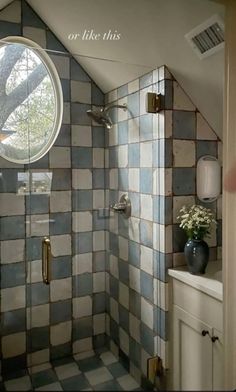 a bathroom with blue and white tiles on the walls