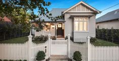 a house with a white picket fence in front of it