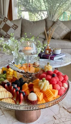 a platter filled with lots of different types of fruit on top of a table