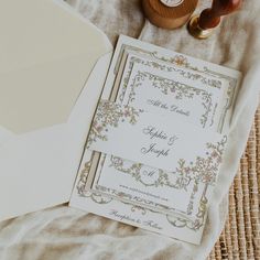 wedding stationery and envelopes laid out on top of a table with some type of paper