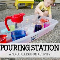 a toddler playing in a plastic container filled with water and liquid while pouring station