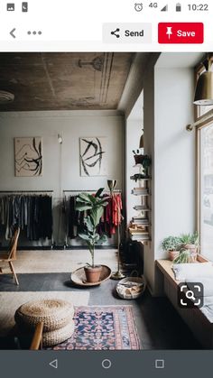 a living room filled with furniture next to a window and a rug on the floor