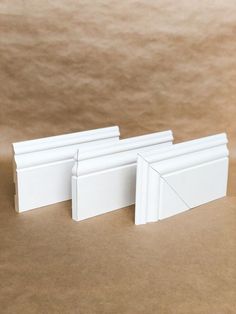 three pieces of white plastic sitting next to each other