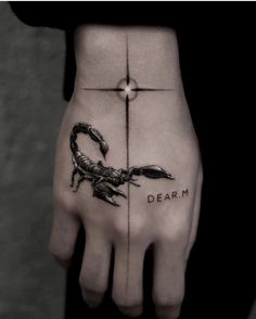 a hand with a scorpion on it and the words dear m written in black ink