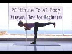 a woman doing yoga in front of a window with the words 20 minute total body vinyas flow for beginners