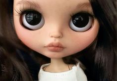 a close up of a doll with big eyes