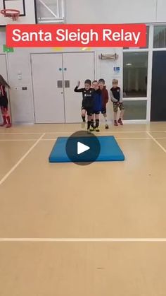 a group of children standing on top of a basketball court