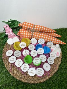 a basket filled with lots of different items on top of a grass covered floor next to a wall