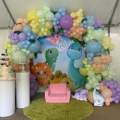 the balloon arch is decorated with various balloons and decorations for a baby's first birthday