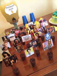 a table topped with lots of pictures and cupcakes on top of each other