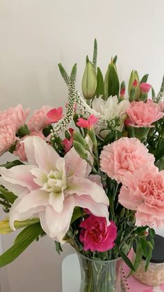 a vase filled with pink and white flowers