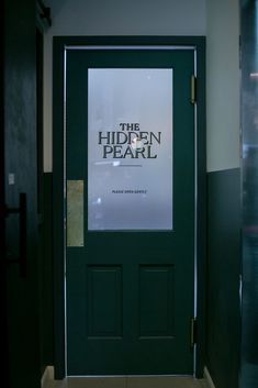 the hidden pearl movie poster is displayed in front of a green door with glass panels