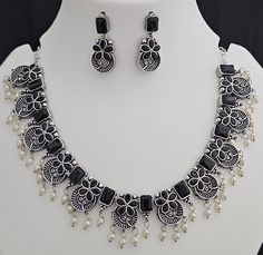 Premium quality partywear Oxidized silver Black Color stone Necklace with matching Earrings - MK Fashionkart - Fashion Jewelry Material:  Oxidized silver with Black stone Earrings: Beautiful matching earrings Suitable for Saree/Salwar/party wear dresses Adjustable length  SHIPPING : Ready to ship in 1 business day. This item will be shipped from The United States. Jewelry care instructions : 1. Please wipe the jewelry with a piece of cotton cloth after usage.  2. Store the jewelry in a cool, dry and air tight box or pouch.  3. Make sure the jewelry is away from direct heat and water. 4. Please wipe of any moisture, sweat, soap water after usage. Elegant Black Jewelry Sets For Festive Occasions, Elegant Black Festive Jewelry Sets, Festive Silver Sets For Celebration, Festive Silver Celebration Sets, Silver Sets For Festivals, Festive Black Jewelry Sets For Party, Festive Black Necklace For Party, Festive Silver Jewelry Set For Party, Black Stone Earrings