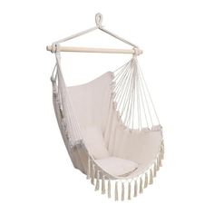 a white hammock chair hanging from a wooden pole