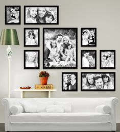 a white couch sitting in front of a wall with pictures hanging on it's side