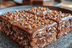 three pieces of chocolate cake on a plate with nuts and nutcracker toppings