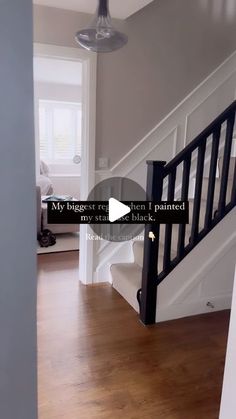 the stairs in this house are painted white and have black railings on each side