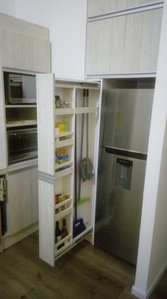 a kitchen with white cabinets and stainless steel refrigerator freezer combo in the corner,