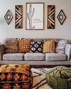 a living room filled with lots of furniture and pillows on top of carpeted flooring