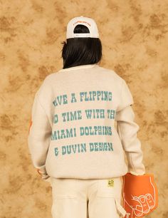 Miami Dolphins x Duvin "A Flippin Good Time" Limited Collection *Knit is exclusive to Duvindesign.com and Dolphins Stadium This knitted vintage Miami Dolphins crewneck takes you back to the era of legends. Crafted from a cozy knit blend, it's got that perfectly worn-in feel, like it’s been passed down from generations of die-hard fans. Knitted with high-quality materials. Relaxed, comfortable fit and perfect layering option with the rest of the Duvin x Dolphins collection. Mid-weight vintage kni Vintage Miami, Suits For Sale, Beach Kids, Beach Pants, Cozy Knit, One Piece Suit, Miami Dolphins, Die Hard, Vintage Knitting