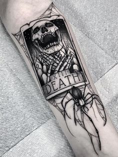 a black and white tattoo on the arm of a person with a hand holding a knife