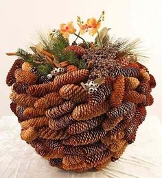 a bunch of pine cones sitting on top of a white tablecloth covered table cloth