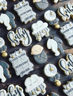 decorated cookies are displayed on a wooden table