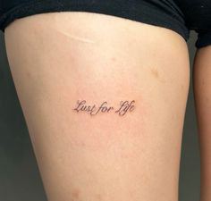 a woman's thigh with the words just for life written on it, in cursive font